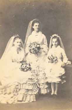 Three young ladies as bridesmaids, uncaptioned but probably depicting Annie Maria Dixon (1853 - 1944), Florence Dixon (1857 - 1935), and Beatrice Helen Dixon (1866 - 1947)