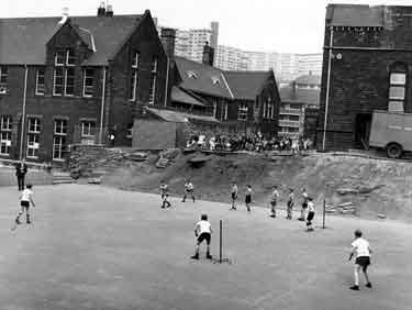 Rounders match in the playground at Park Junior and Infant School, Duke Street formerly Park County School with Duke Street Flats and Hyde Park Flats in the backgound