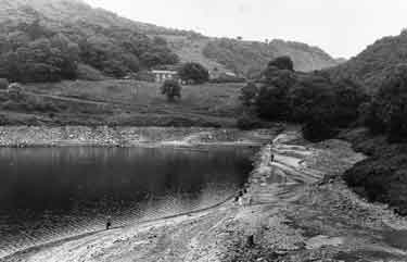 Ladybower Reservoir during the drought, revealing the old road bridge 