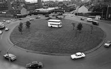 Brook Hill roundabout with double decker bus in the centre of the roundabout