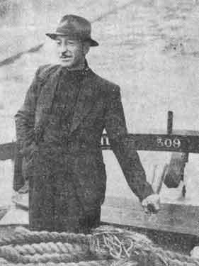 John Hunt, skipper of the M.V. Ready at the tiller, Sheffield Canal Basin