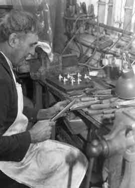 Un-named silversmith in his workshop.