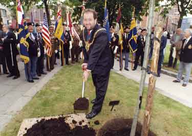 Lord Mayor, Councillor Ian Saunders planting a tree outside the Crucible Theatre to commemorate the anniversary of D-Day