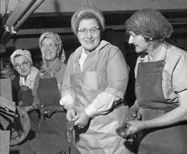Buffer girls buffing forks at unidentified factory