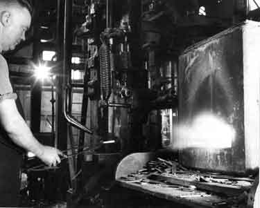 Bob Willerton stamping out a blade under a power hammer in the forging shop, Joseph Rodgers and Sons Ltd. River Lane Works at the junction of Sheaf Street and Pond Hill