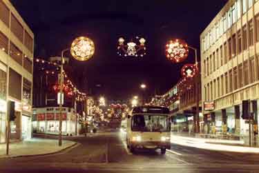 Christmas decorations on Pinstone Street at junction with (foreground) Furnival Gate