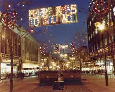 Christmas decorations on The Moor showing (left) Nos. 6-7 Quadrant stationers and Nos. 15-19 F.W.Woolworth and Co. Ltd., department store