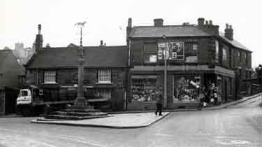Market Square, Woodhouse showing (left) No. 14 Cross Daggers public house, No.12 Scarrotts Stores Ltd., china and glass dealers and (foreground) Woodhouse Market Cross