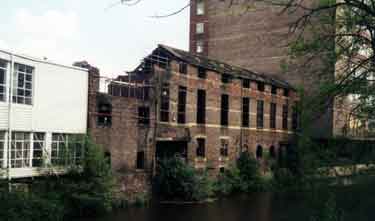 Derelict factory buildings at the rear of Savile Street on the River Don showing (right) Saville House