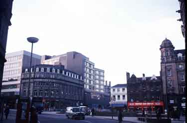 Town Hall Square from Surrey Street showing (centre) Goodwin Fountain and shops on Fargate including (l.to r.) (Nos.70-62) H.L.Brown and Son Ltd., jewellers and Western Jean Company and (left) Wilson Peck Ltd., music warehouse, Nos.66-70, Leopold St