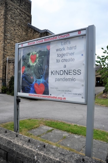 Notice board outside Banner Cross Methodist Church during the Covid-19 pandemic: Let's work hard together to create a kindness pandemic