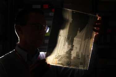 Sheffield City Council's Archives and Heritage Manager, Pete Evans, examining a glass negative