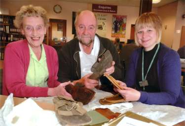 Cheryl Bailey, Senior Archivist (right) with Barbara Neill (left), Archives and Local Studies Dept., No. 54 Shoreham Street and Rony Robinson (BBC Radio Sheffield) looking at Edward Carpenter's sandals