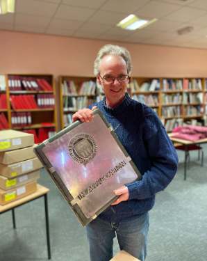 Archivist Robin Wiltshire with a stainless steel volume newly acquired by Sheffield City Archives