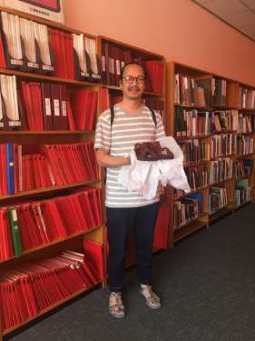 Presentation of sandals to Sheffield City Archives by Yuen Fong Ling