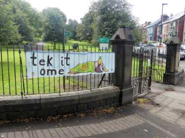 'Tek it home', anti litter banner on railings at entrance to Meersbrook Park, Meersbrook Park Road and (right) Brook Road