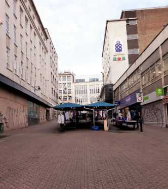Street market on King Street showing (top right) Brightside and Carbrook Cooperative Society, Angel Street