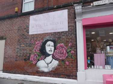 Mural of Queen Elizabeth II by artist Paul Staveley on Valley Road side of Blynk, lash and brow salon, No. 67 Chesterfield Road