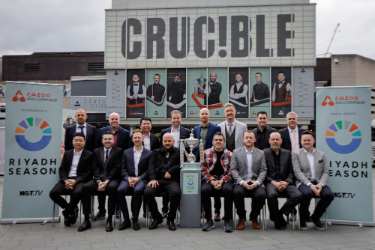 The worlds' top 16 snooker players with the World Snooker Tour Championship trophy in front of the Crucible Theatre, Tudor Square