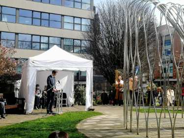 Councillor Tom Hunt, Leader of the Council speaking in Balm Green Gardens, Covid Memorial Day, 2025 showing (right) the Covid Pandemic Memorial Tree