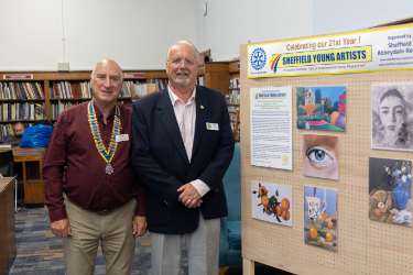Graham Stevens and Chris Jones (right) of Abbeydale Rotary Club with a Sheffield Young Artists display at Sheffield Central Library