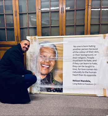 Sheffield City Council's Head of Employee Engagement, Inclusion and Wellbeing, James Jackson with a new portrait of Nelson Mandela, Sheffield Town Hall