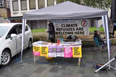 Stand with banner reading 'Climate Refugees are Welcome Here' at the demonstration against Racism and in support of refugees, Tudor Square