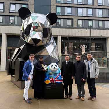 The Chinese Consul General from the Manchester Consulate, Tang Rui, presenting the Lord Mayor of Sheffield, with a panda statue on behalf of Chengdu City Government
