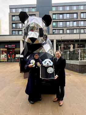 The Chinese Consul General from the Manchester Consulate, Tang Rui, presenting the Lord Mayor of Sheffield, with a panda statue on behalf of Chengdu City Government