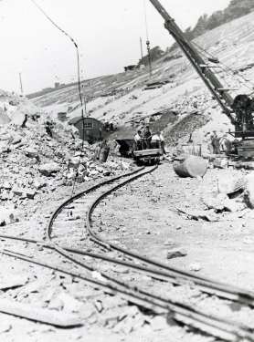 Crane and buggies at the Broomhead reservoir during the construction of the Ewden Valley reservoirs