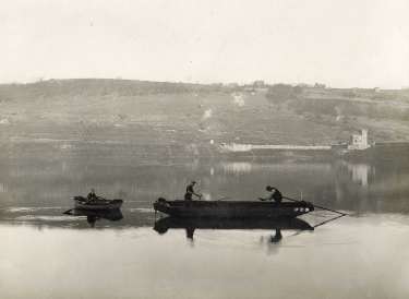 Spreading coke dust on Broomhead reservoir during the construction of the Ewden Valley reservoirs 