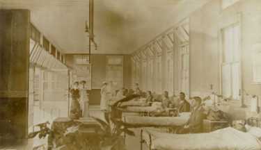 Block 14 men's sanatorium ward, City General Hospital (later known as the Northern General Hospital), Fir Vale showing (left) Dr [Marion] Stokes, [anaesthetist] and Miss [Amelia] Lawson, matron, c. 1910