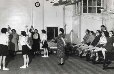 Nurses with patients during exercise session, probably School of Physiotherapy, Westbourne [House], Collegiate Crescent