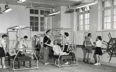 Nurses with patients during exercise session, probably School of Physiotherapy, Westbourne [House], Collegiate Crescent
