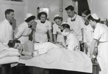 Nurses with doctor examining a patient, probably Edgar Allen Institute, No.77 Gell Street