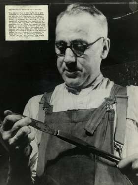 Tempering a blade at Walker and Hall Ltd., Electro Works, junction of Howard Street and Eyre Street