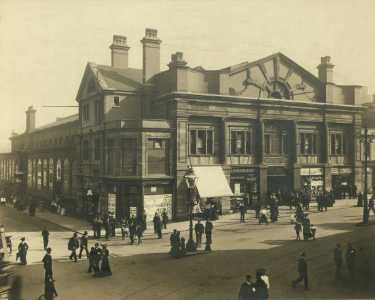 New west end to the Norfolk Market Hall, Haymarket showing (centre) T. P. Rodgers, music and musical instrument warehouse and (right) The People's Boot Market