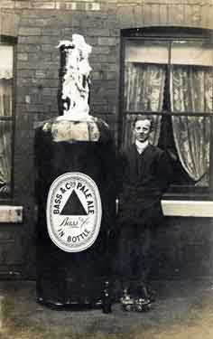 Unidentified man standing next to a bottle of Bass and Co.'s Pale Ale
