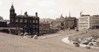 Commercial Street from Sheaf Street showing (left) Electricity Supply Offices, Wheel Hill, (centre) Marsh Brothers and Co. Ltd., steel engineers tools, Ponds Works, Shude Lane and (right) Commercial Street Bridge and Barclays Bank