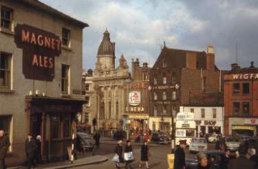 Junction of Norfolk Street looking towards Fitzalan Square showing (left) The Elephant Inn, Nos 2- 4 Norfolk Street, (centre) The Jolson Story playing at the Classic Cinema and (right) Wigfalls, electrical store