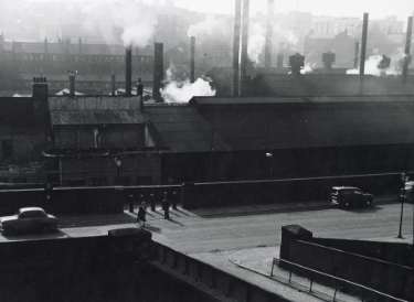 Smoke and chimneys above George Senior and Sons Ltd., steel manufacturers, Ponds Forge, Sheaf Street as seen from Granville Street c.1957