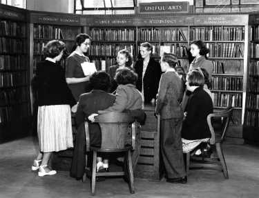Miss Charlesworth with a group of children in the Central Library during school instruction