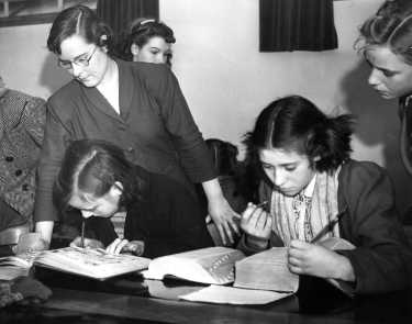 Miss Spurr with a group of girls in the Library Committee Room, Central Library during school instruction