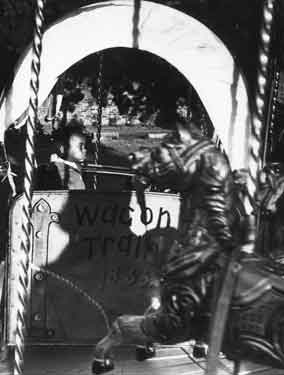Child on wagon train fairground ride
