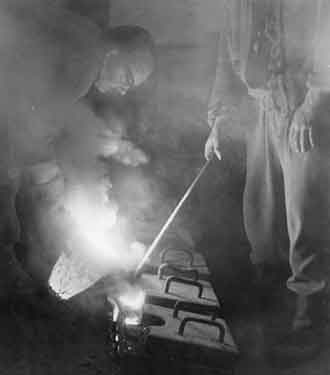 Brian Lidster and Mark Franey, metalsmiths, casting metal at the Brass Foundry, Carver Lane