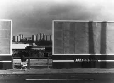 Empty advertising hoardings on unidentified street showing (back centre) Norfolk Park flats