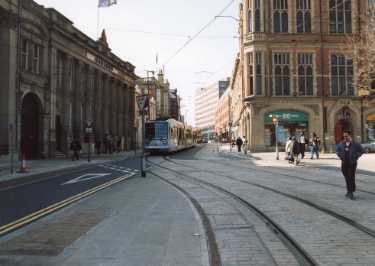 Supertram No. 15 on Church Street showing (left) Cutlers Hall and (right) Halifax Property Services, Gladstone Buildings, No. 2 Church Street