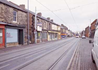 Supertram on Holme Lane showing (left) No. 118 P. L. E., electrical engineers and contractors and (centre) Nos. 108 - 110 Crocatile Discount Centre