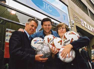 Group including (centre) Chris Waddle and (right) Councillor Sylvia Dunkley outside South Yorkshire Passenger Transport Executive (SYPTE), Travel Information Centre (TIC), Cambridge Street, Sheffield