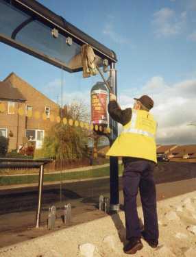 Contractor cleaning a bus shelter